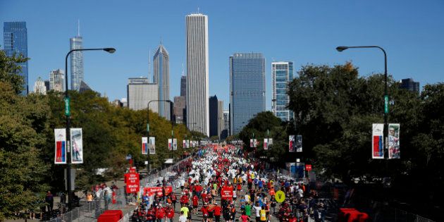 Runners walk through the finish area after completing the Chicago Marathon on Sunday, Oct. 13, 2013, in Chicago. (AP Photo/Andrew A. Nelles)