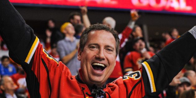 CALGARY, AB - MARCH 12: A fan of the Calgary Flames celebrates after a goal against the Anaheim Ducks during an NHL game at Scotiabank Saddledome on March 12, 2014 in Calgary, Alberta, Canada. (Photo by Derek Leung/Getty Images)