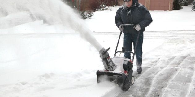 man working with a snow blowing ...