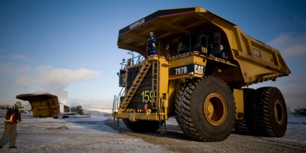 FORT MCMURRAY, ALBERTA, CANADA - NOVEMBER 2008: Caree Simms, 32, has been driving one of these trucks, the world's biggest, for the past 2 years. She earns over CAD $100,000 per year. Shell Albian Sands, is one of the biggest companies exploiting the tar sands in Alberta, northern Canada. Tar sands, or oil sands, are very dense and contain a form of petroleum The world's largest reserves of tar sands in Canada and Venezuela. Tar sands could equate to approximately two thirds of the total global petroleum resource. Until recently it was financially not viable to extract the oil from the sands, but new technology and rising oil prices have now made it viable. (Photo by Veronqiue de Viguerie/Getty Images)