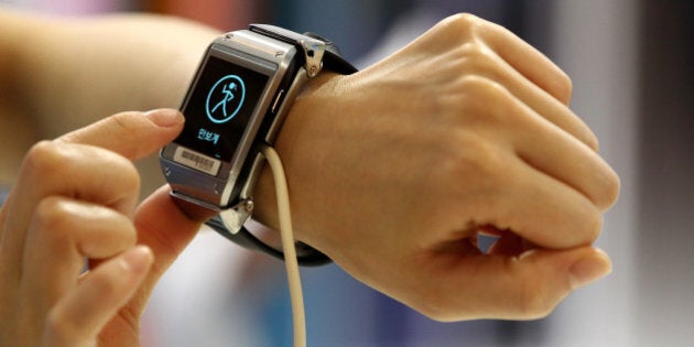 An event employee tries out a Samsung Electronics Co. Galaxy Gear smartwatch at the launch event for the company's Galaxy Note 3 smartphone and Galaxy Gear smartwatch in Seoul, South Korea, on Wednesday, Sept. 25, 2013. Samsung is releasing the new devices in 58 countries today, expanding to approximately 140 countries by next month, according to an emailed statement. Photographer: SeongJoon Cho/Bloomberg via Getty Images