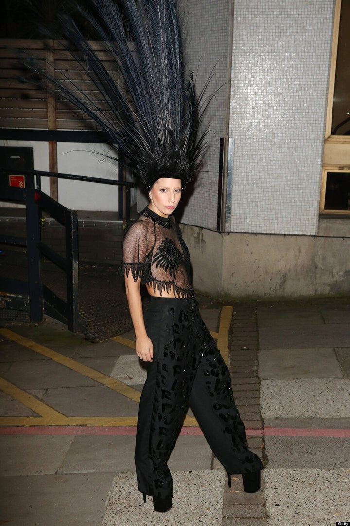 Lady Gaga comes a cropper in Louis Vuitton feather headdress