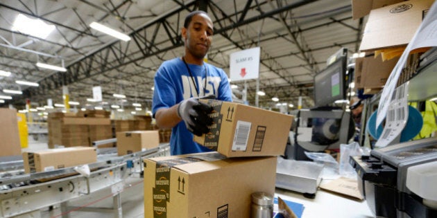 SAN BERNARDINO, OCTOBER 29: Employee Lamar Roby prepares shipping orders at Amazon's San Bernardino Fulfillment Center October 29, 2013 in San Bernardino, California. Amazon's 1 million square-foot facility in the hard hit San Bernardino County has created more than 800 jobs at the center. Fulfillment centers are where products sold by other vendors on Amazon.com store their inventory. (Photo by Kevork Djansezian/Getty Images)