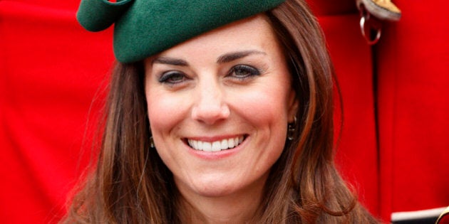 ALDERSHOT, UNITED KINGDOM - MARCH 17: (EMBARGOED FOR PUBLICATION IN UK NEWSPAPERS UNTIL 48 HOURS AFTER CREATE DATE AND TIME) Catherine, Duchess of Cambridge poses for a group photograph with soldiers of the Irish Guards as she attends the St Patrick's Day Parade at Mons Barracks on March 17, 2014 in Aldershot, England. Catherine, Duchess of Cambridge and Prince William, Duke of Cambridge visited the 1st Battalion Irish Guards to present the traditional sprigs of Shamrocks to the Officers and Guardsmen of the Regiment. (Photo by Max Mumby/Indigo/Getty Images)