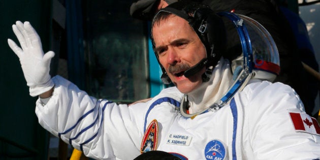 Canadian astronaut Chris Hadfield, a crew member of the mission to the International Space Station, gestures prior the launch of the Soyuz-FG rocket at the Russian leased Baikonur cosmodrome, Kazakhstan, Wednesday, Dec. 19, 2012. (AP Photo/Dmitry Lovetsky, Pool)