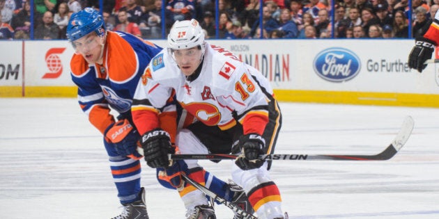 EDMONTON, AB - MARCH 22: Taylor Hall #4 of the Edmonton Oilers tries to check Mike Cammalleri #13 of the Calgary Flames during an NHL game at Rexall Place on March 22, 2014 in Edmonton, Alberta, Canada. (Photo by Derek Leung/Getty Images)