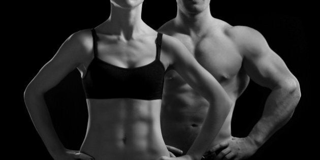 Bodybuilding. Strong man and a woman posing on a black background