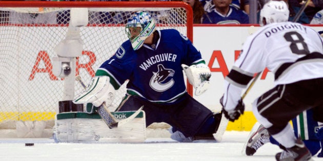 VANCOUVER, CANADA - APRIL 11: Roberto Luongo #1 of the Vancouver Canucks makes a save as Drew Doughty #8 of the Los Angeles Kings looks on during the second period in Game One of the Western Conference Quarterfinals during the 2012 NHL Stanley Cup Playoffs at Rogers Arena on April 11, 2012 in Vancouver, British Columbia, Canada. (Photo by Rich Lam/Getty Images)