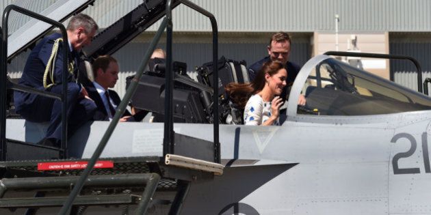 BRISBANE, AUSTRALIA - APRIL 19: Commanding Officer of Number 1 Squadron, Wing Commander Stephen Chappell (R), gives details to Catherine, the Duchess of Cambridge (L) as she sits in the cockpit of a RAAF Super Hornet of 1 Squadron as her husband Prince William, Duke of Cambridge (2nd L) sits in the rear seat talking with Chief of Air Force, Air Marshal Geoff Brown (L) at the Royal Australian Airforce Base at Amberley on April 19, 2014 in Brisbane, Australia. The Duke and Duchess of Cambridge are on a three-week tour of Australia and New Zealand, the first official trip overseas with their son, Prince George of Cambridge. (Photo by William West - Pool/Getty Images)