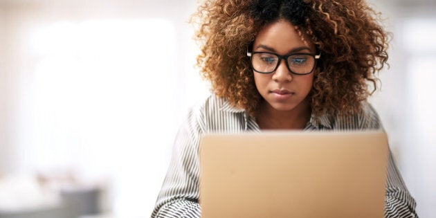 Cropped shot of a young woman working on her laptop