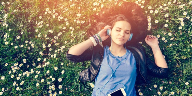 Girl lying down in the grass - copyspace