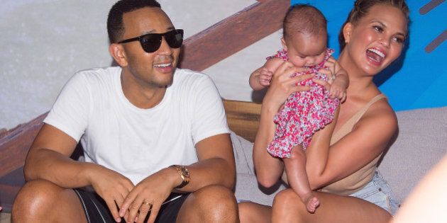 BROOKLYN, NY - AUGUST 28: Model Chrissy Teigen and musician John Legend with their baby Luna Simone Stephens attend the 2016 Sports Illustrated Summer Of Swim Fan Festival & Concert at Ford Amphitheater at Coney Island Boardwalk on August 28, 2016 in Brooklyn, New York. (Photo by Michael Stewart/WireImage)
