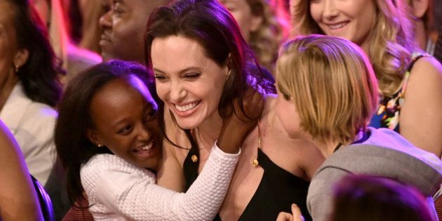 INGLEWOOD, CA - MARCH 28: Actress Angelina Jolie hugs Zahara Marley Jolie-Pitt (L) and Shiloh Nouvel Jolie-Pitt (R) after winning award for Favorite Villain in 'Maleficent' during Nickelodeon's 28th Annual Kids' Choice Awards held at The Forum on March 28, 2015 in Inglewood, California. (Photo by Kevin Winter/Getty Images)