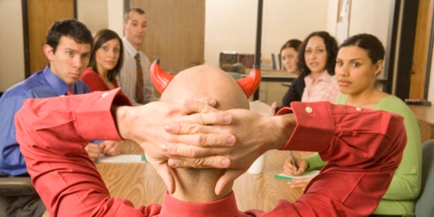 Businessman with devil horns at meeting