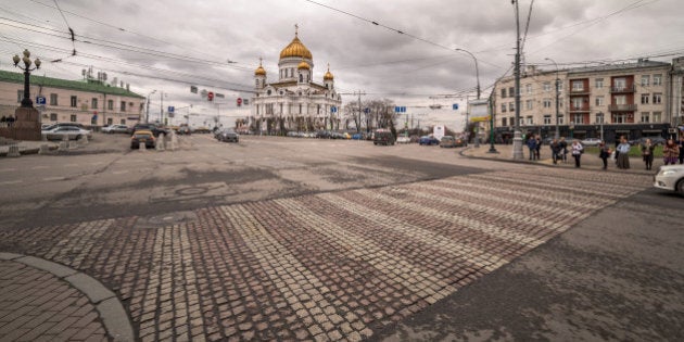 A wide angle view of a crossroad near the Christ the Savor church under nasty cloudy sky