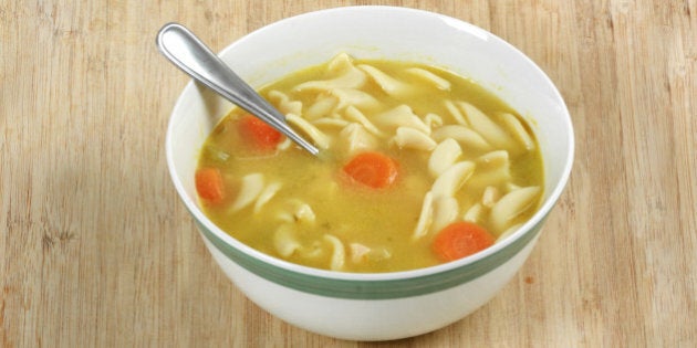 Chicken noodle soup on cutting board