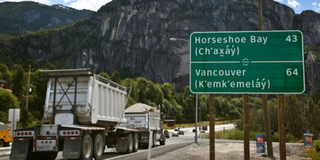 A bilingual roadside mileage sign is shown along the Sea to Sky Highway in Squamish, British Columbia, July 22, 2010. The signs have been erected written in both English and the language of the Squamish and Lil'Wat First Nations bands who traditionally lived in the area between Vancouver and Whistler. The signs are part of large scale improvements made to the road connecting to two main sites of the 2010 Olympic Winter Games held earlier this year. REUTERS/Andy Clark (CANADA - Tags: TRANSPORT SOCIETY TRAVEL)