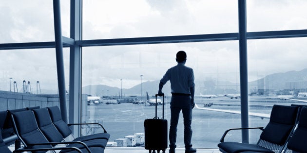 business traveler with luggage waiting for his flight.