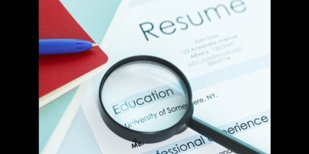 A magnifying glass on a resume magnifying the education section of the resume. Ideal image for job search and education themes. ++Note: University of Somewhere is a generic fictitious university name++