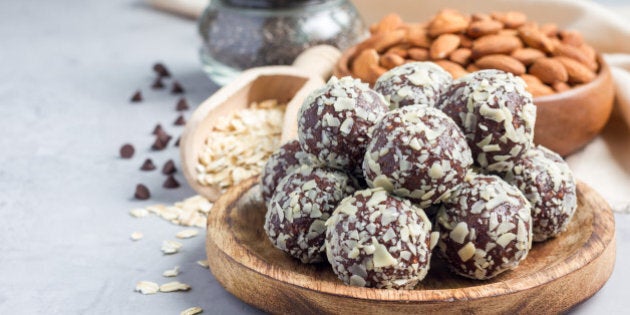 Healthy homemade paleo chocolate energy balls with rolled oats, nuts, dates and chia seeds, horizontal, copy space