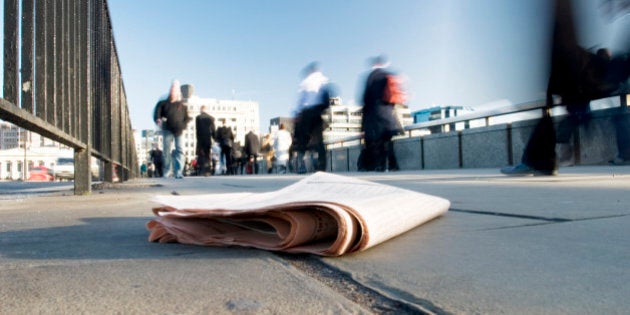 A discarded newspaper among commuters