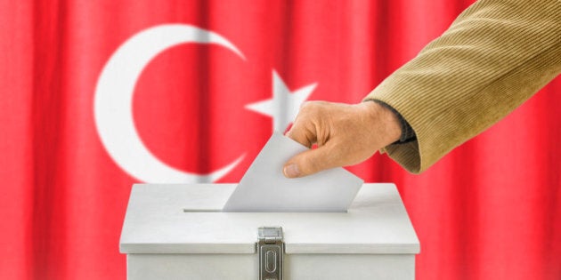 Man putting a ballot into a voting box - Turkey