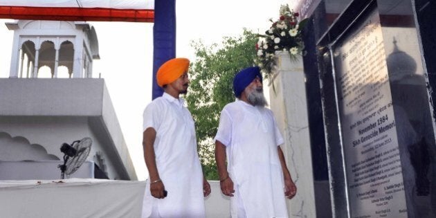 NEW DELHI, INDIA - JUNE 12: Devotees look at just laid foundation stone of November 1984 Sikh Genocide Memorial at Gurudwara Rakab Ganj on June 12, 2013 in New Delhi, India. Allegedly more than 8,000 Sikhs died including 3,000 in Delhi during the 1984 anti-Sikhs riots or the 1984 Sikh Massacre by anti-Sikh mobs, in response to the assassination of Indira Gandhi by her Sikh bodyguards. (Photo by Vipin Kumar/Hindustan Times via Getty Images)