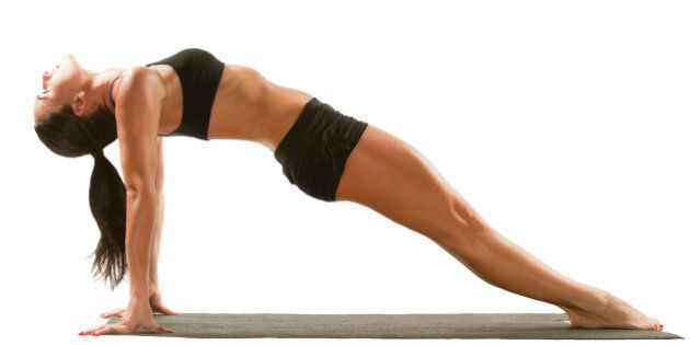 Sexy young yoga female doing yogic exercise on isolated white background