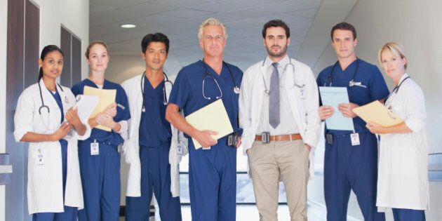 Portrait of confident doctors and nurses in hospital corridor