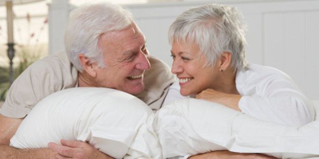 Laughing Seniors on Bed