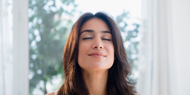 Calm woman breathing with eyes closed