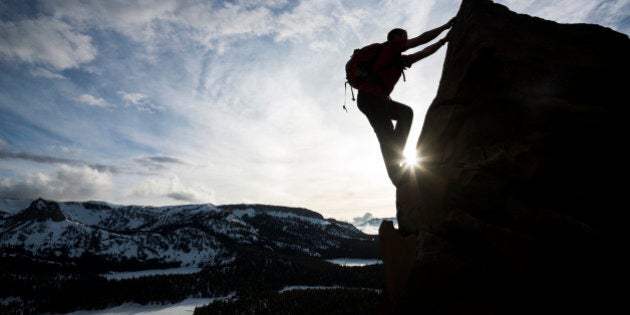 mountain climber going to the summit