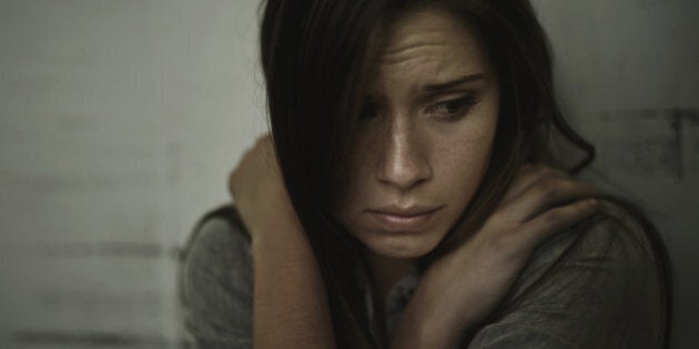 A young woman looking anxious and fearful