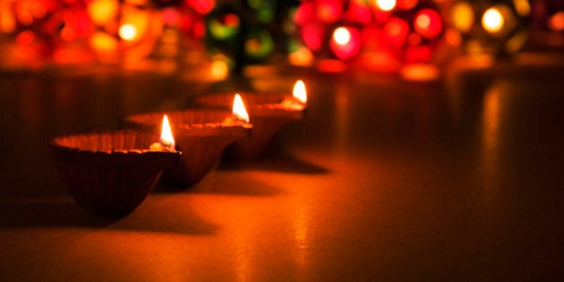 three beautiful diwali diyas, selective focus, bokeh in the background, perfect for diwali greeting