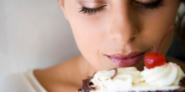 Woman smelling cake