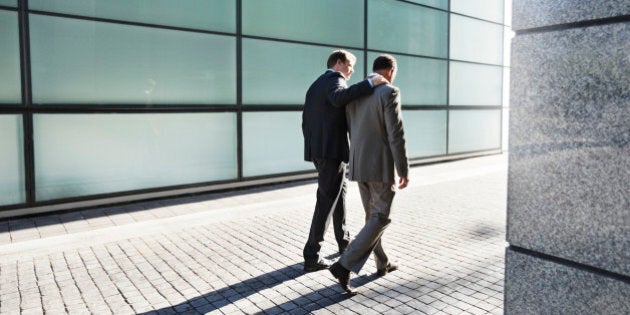 Businessmen talking on city street