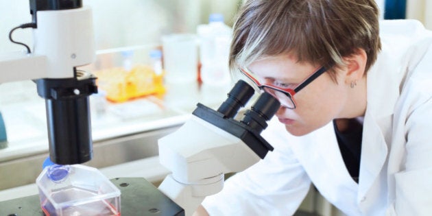 woman scientist looking at the microscope