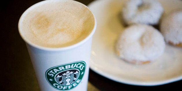 A Starbucks Corp. new low calorie vanilla latte and mini sparkle doughnuts are arranged for a photograph in New York, U.S., on Wednesday, Jan. 13, 2010. New Yorkers were more inclined to buy coffee from Starbucks Corp., especially from stores near a Dunkin' Donuts outlet, after restaurant chains were required to display calorie counts on products, researchers found. Photographer: Ramin Talaie/Bloomberg via Getty Images