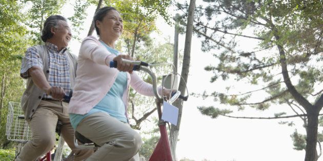 Older couple riding tandem bicycle, Beijing