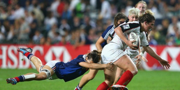 HONG KONG - MARCH 28: Kelly Russell of Canada is tackled during the Women's Final match between Canada and France during day one of the 2014 Hong Kong Sevens at Hong Kong International Stadium on March 28, 2014 in Hong Kong, Hong Kong. (Photo by Cameron Spencer/Getty Images)