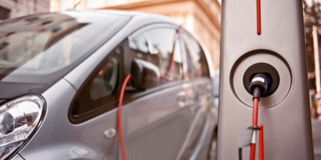 An electric car in charging on the street