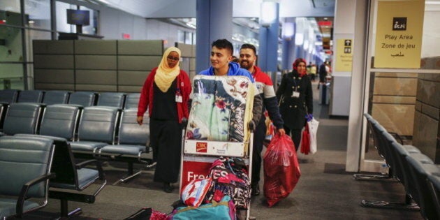 Syrian refugees arrive at the Pearson Toronto International Airport in Mississauga, Ontario, December 18, 2015. REUTERS/Mark Blinch