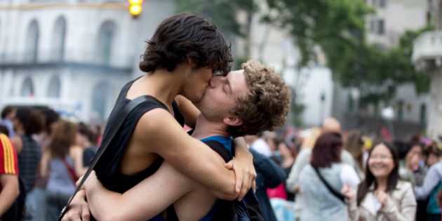 Men kiss during the annual gay pride parade in Buenos Aires, Argentina, Saturday, Nov. 9, 2013. Argentina was the first country in Latin America to legalize same-sex marriage, and in 2012 Congress approved the Argentina Gender Identity Law, enabling people to change their names and sexes on official documents without first getting approval from a judge or doctor. No other country in the world allows people to change their official identities based on how they feel. (AP Photo/Natacha Pisarenko)
