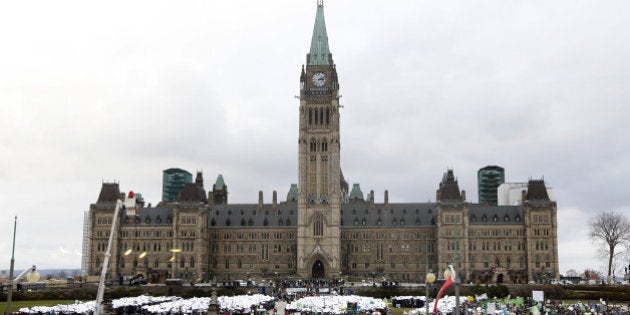 People participate in the The 100% Possible Climate March on Parliament Hill in Ottawa, on November 29, 2015. Some 150 leaders, including US President Barack Obama, China's Xi Jinping, India's Narendra Modi and Russian President Vladimir Putin, will attend the start of the Paris conference, which is tasked with reaching the first truly universal climate pact, with the goal to limit average global warming to two degrees Celsius (3.6 degrees Fahrenheit), perhaps less, over pre-Industrial Revolution levels by curbing fossil fuel emissions blamed for climate change. AFP PHOTO/PATRICK DOYLE / AFP / PATRICK DOYLE (Photo credit should read PATRICK DOYLE/AFP/Getty Images)