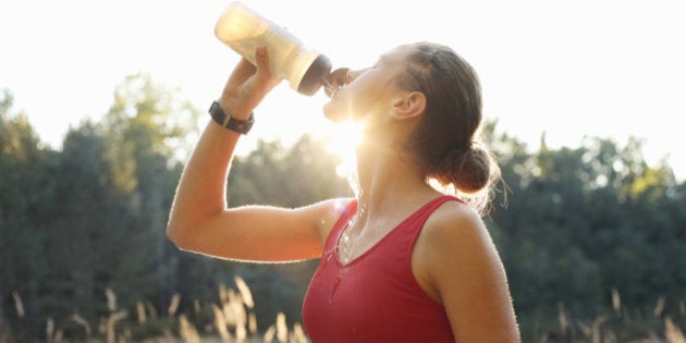 Female athlete rehydrating after training run