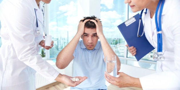 Scared man sitting at doctor's office