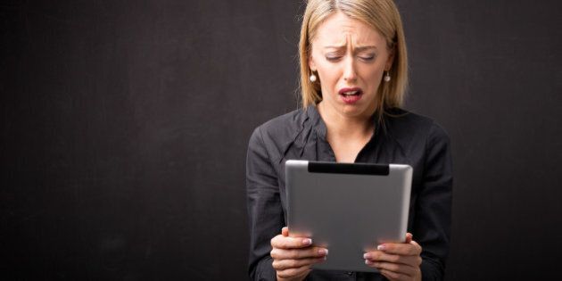 Frustrated woman using tablet