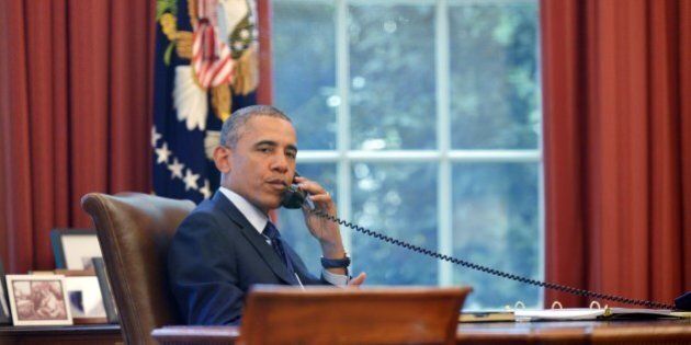US President Barack Obama speaks on the phone during a conference call hosted by public health groups on June 2, 2014 in the Oval Office of the White House in Washington, DC. AFP PHOTO/Mandel NGAN (Photo credit should read MANDEL NGAN/AFP/Getty Images)