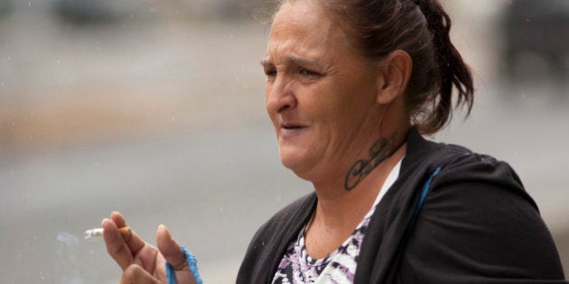 Samantha Leialoha Watanabe stands outside federal court before her sentencing in Honolulu, Tuesday, May 3, 2016. The Hawaii mother was convicted of assaulting her 15-month-old daughter on a flight from Alaska to Hawaii. Watanabe was sentenced to three months of home detention and one month in jail after several failed attempts to get a new trial. (AP Photo/Caleb Jones)