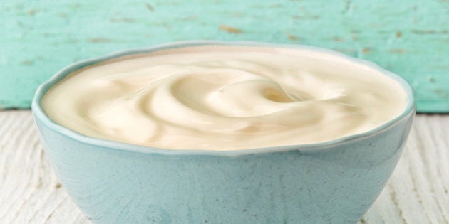 bowl of greek yogurt on white wooden table